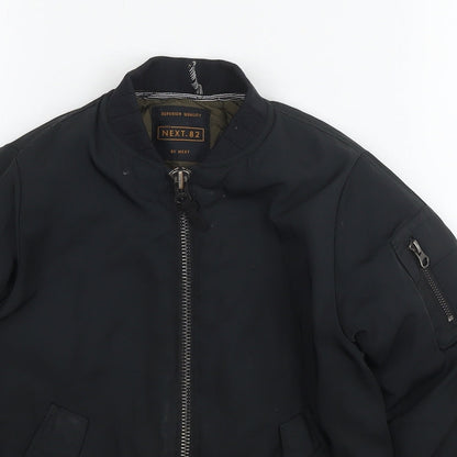 Close-up detail of Next boys’ black jacket, size 6, years zip