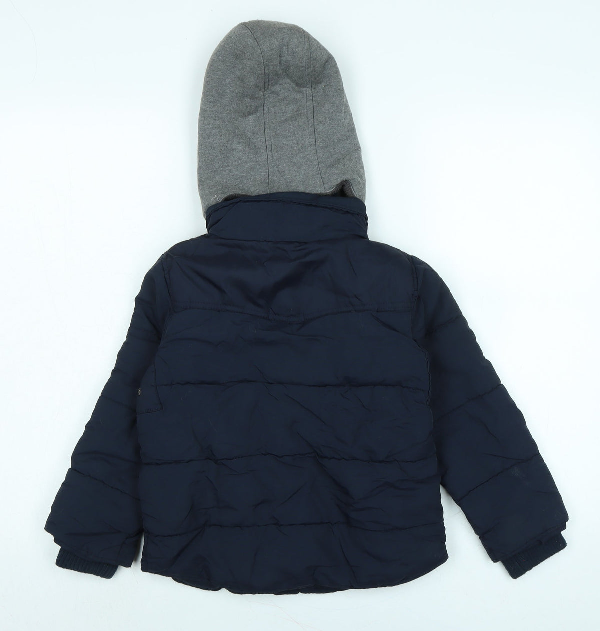 Back view of Next boys’ blue quilted coat, size 5, years zip