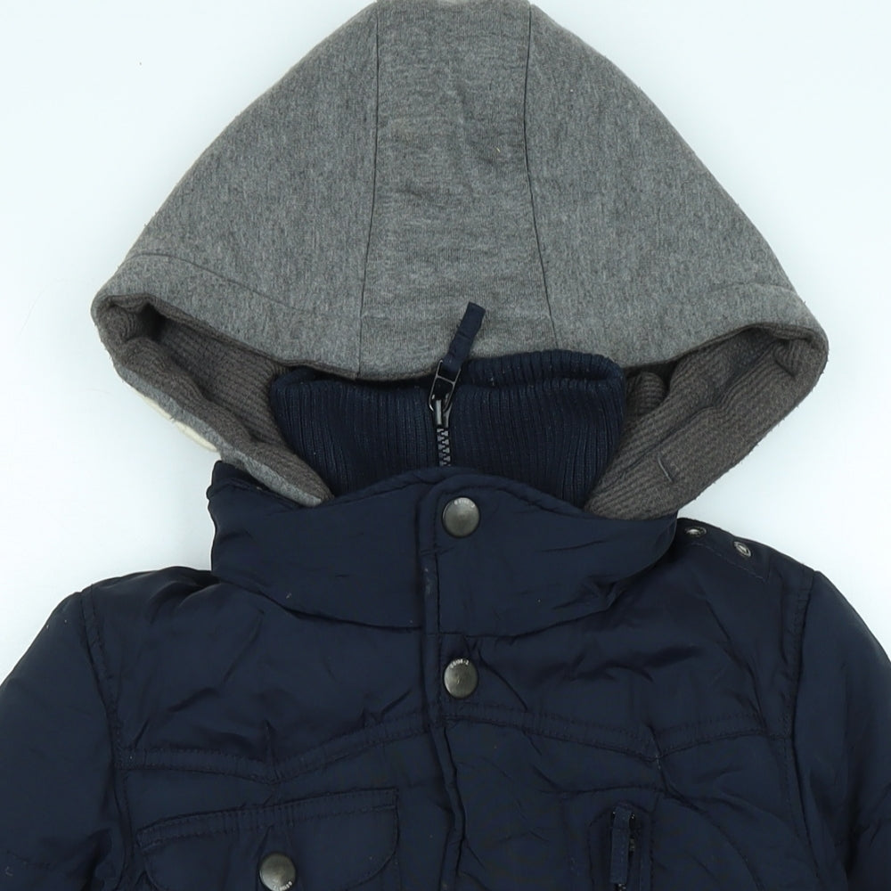 Close-up detail of Next boys’ blue quilted coat, size 5, years zip