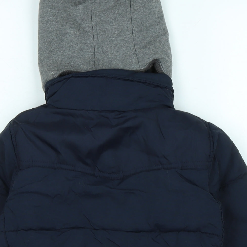 Brand and care label for Next boys’ blue quilted coat, size 5, years zip