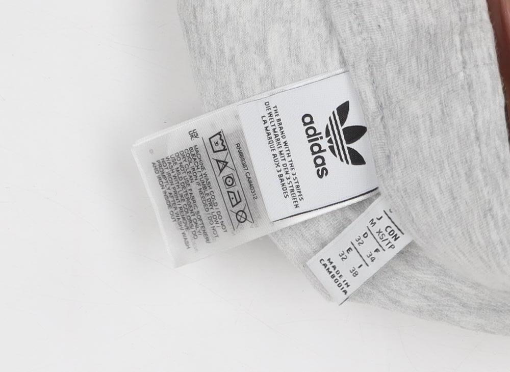 Close-up detail of Adidas boys’ grey athletic shorts, size 34