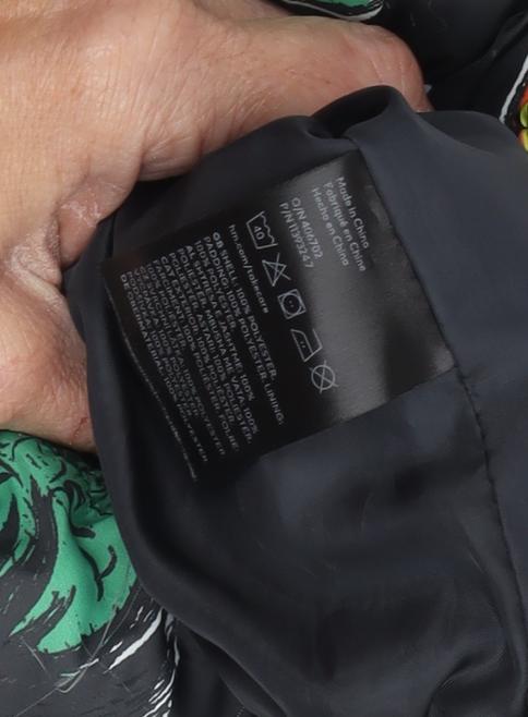Close-up detail of Marvel boys’ black puffer jacket 10-11 years superhero print