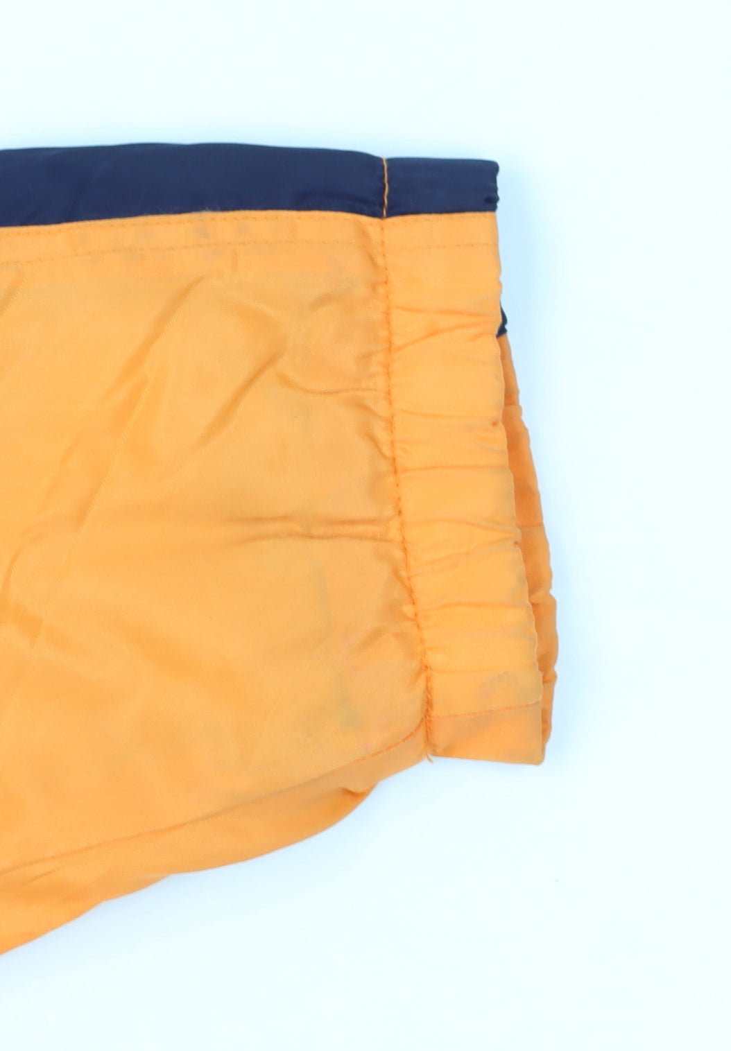 Brand and care label for Games By Power Mark boys’ orange jacket, size 11, years, reflective