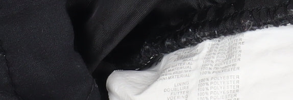 Close-up detail of Trespass boys’ quilted black winter jacket 7-8 years