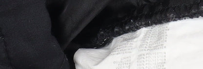 Close-up detail of Trespass boys’ quilted black winter jacket 7-8 years