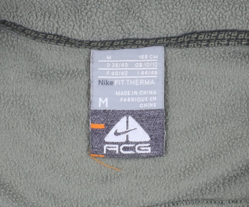 Close-up detail of Nike boys’ green track jacket m full zip for running