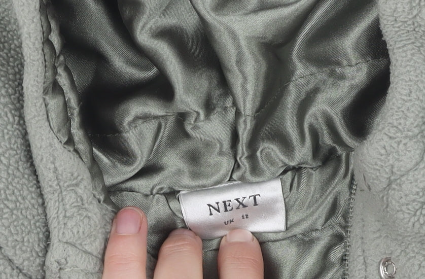 Brand and care label for Next girls’ green hooded polyester jacket - 12 years