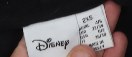 Close-up detail of Disney unisex black pullover hoodie 2xs with logo