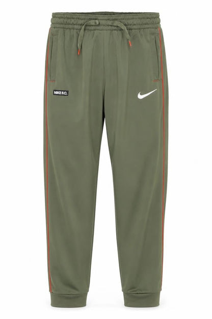 Front view of Nike boys’ green track pants m athletic fit