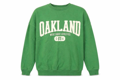 Front view of H&M girls’ green graphic sweatshirt, size 12-13y pullover