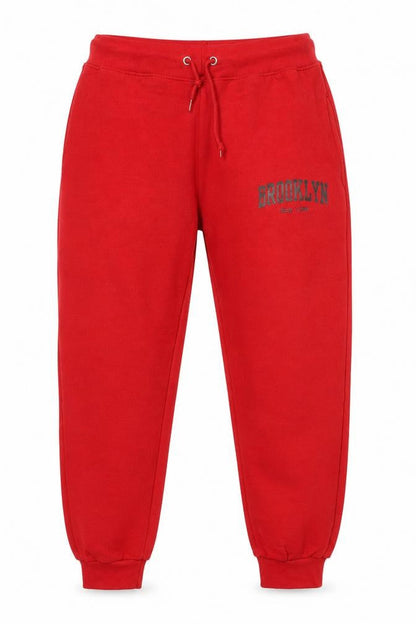 Front view of North West Red Jogger Trousers L unisex with logo