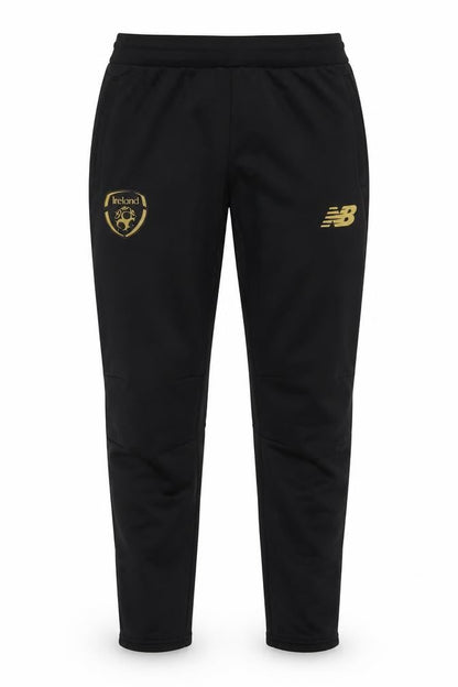 Front view of New Balance boys’ black xl track pants football training tapered fit