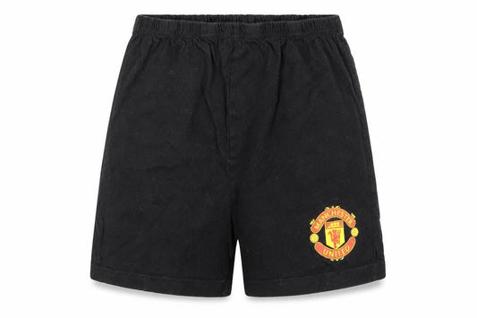 Front view of Manchester United boys’ black 10-11 years cotton athletic football shorts