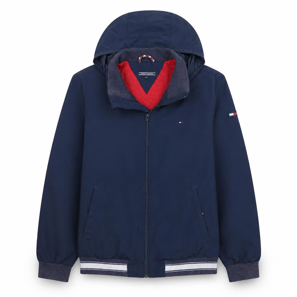 Front view of Tommy Hilfiger boys’ blue hooded windbreaker jacket, size 14, years