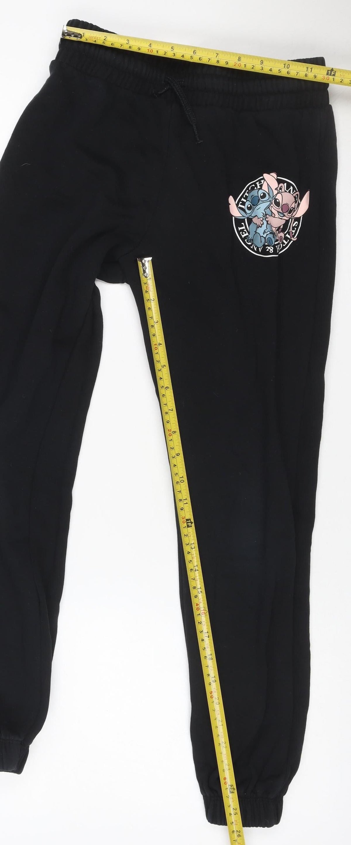 Close-up detail of Disney girls’ black 9-10 years stitch & angel jogger sweatpants