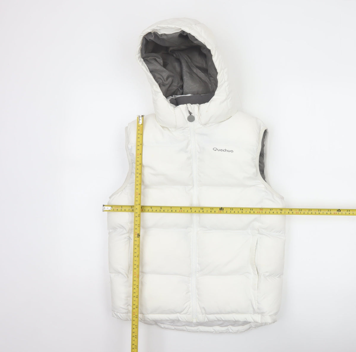 Close-up detail of Quechua girls’ white 12 years hooded padded puffer gilet waistcoat