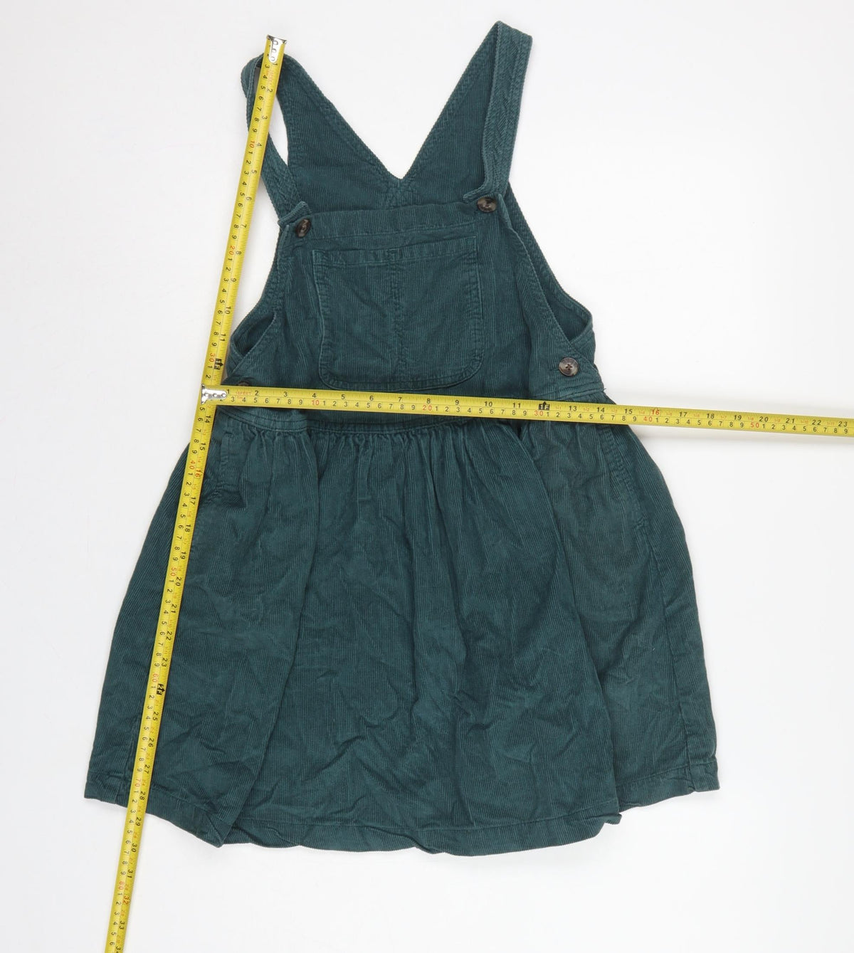 Close-up detail of Next girls’ green corduroy pinafore dress 7 years knee length cotton